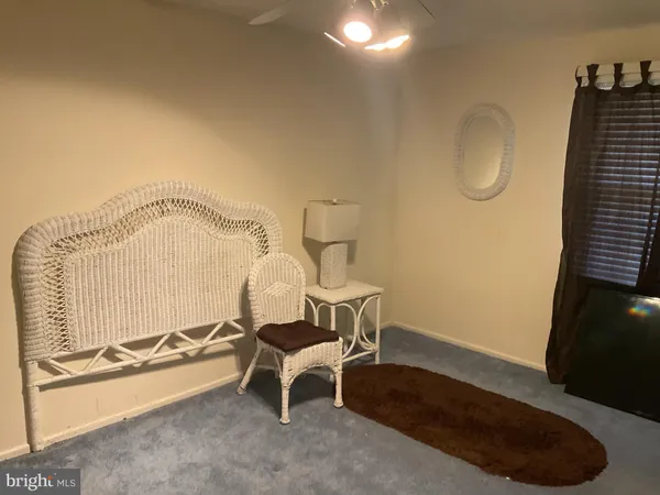 a view of a room with gym equipment and wooden floor