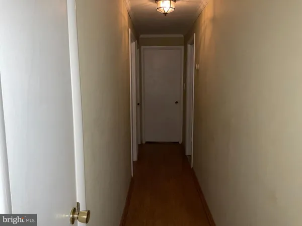a view of a hallway with a room