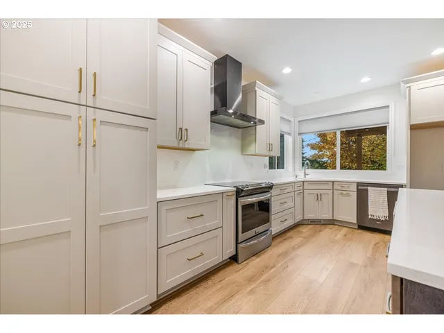 a kitchen with a stove a refrigerator and a sink