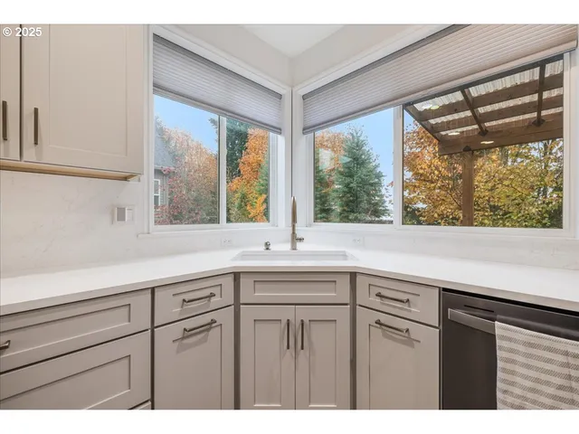a kitchen with a sink and large window