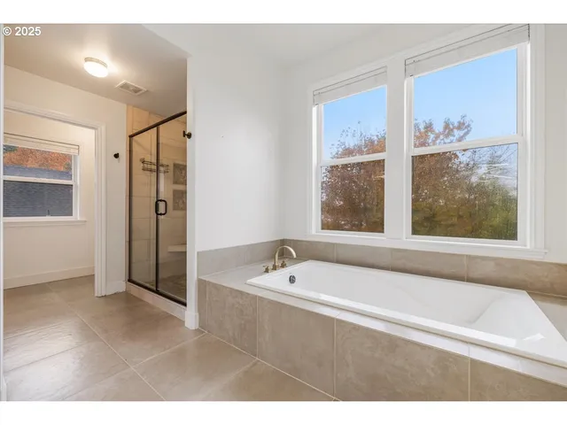 a bathroom with a bathtub and a shower