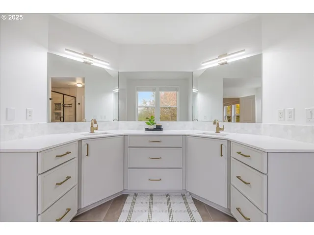 a spacious bathroom with a sink a mirror a vanity and a bathtub