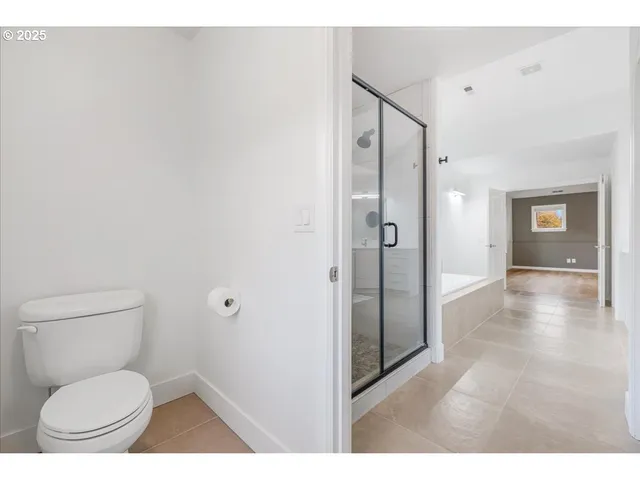 a bathroom with a toilet and a shower