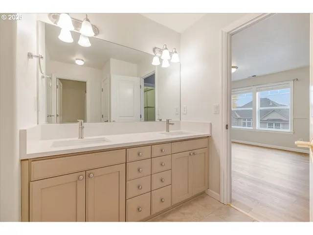 a bathroom with a double vanity sink and a mirror