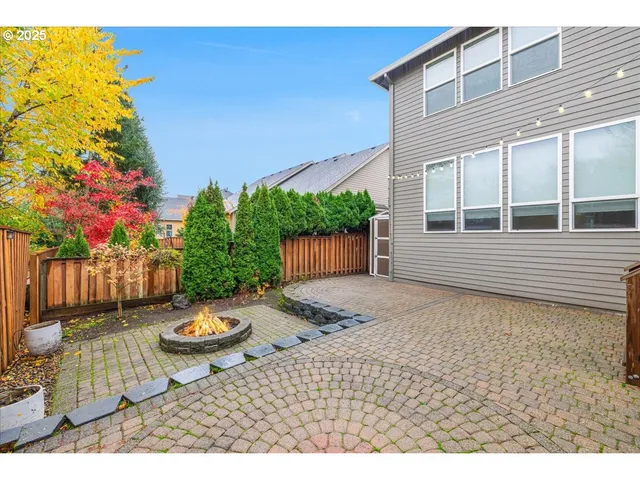 a view of a backyard with table and chairs and potted plants