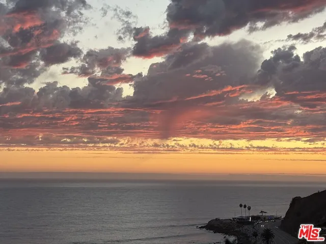 a view of roof deck with dining table and chairs