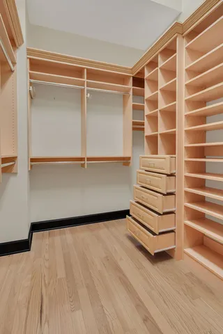 a view of a room with wooden floor and white walls