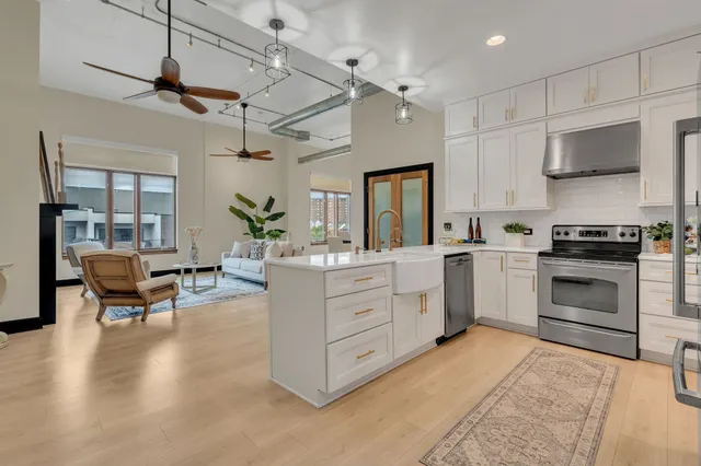 a kitchen with white cabinets and stainless steel appliances