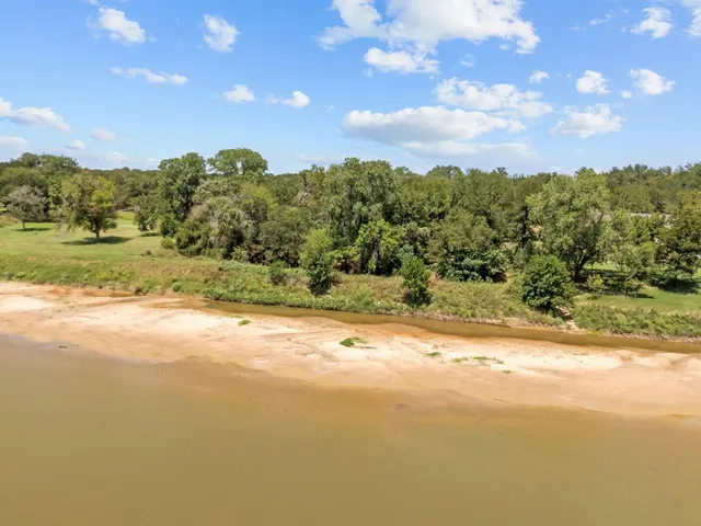 a view of a big yard with lots of green space