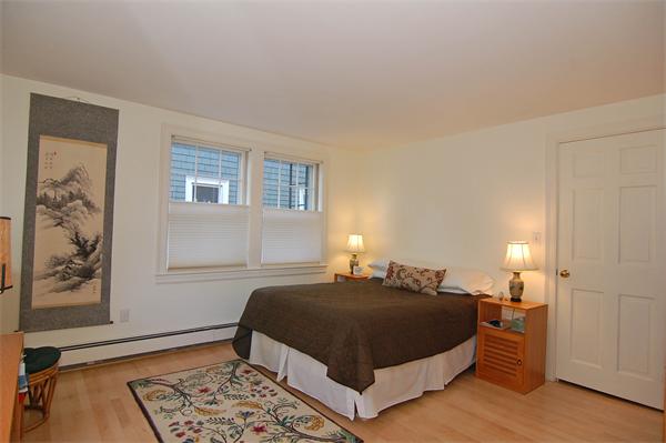 226 Upland Road Cambridge, MA 02140 - Photo 16 of 26 a bedroom with a bed lamp and a window
