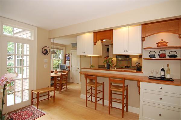 226 Upland Road Cambridge, MA 02140 - Photo 8 of 26 a kitchen with stainless steel appliances a table and chairs in it