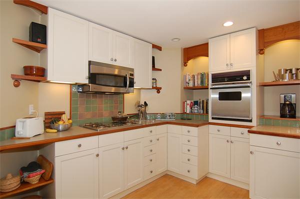226 Upland Road Cambridge, MA 02140 - Photo 9 of 26 a kitchen with granite countertop cabinets stainless steel appliances and wooden floor