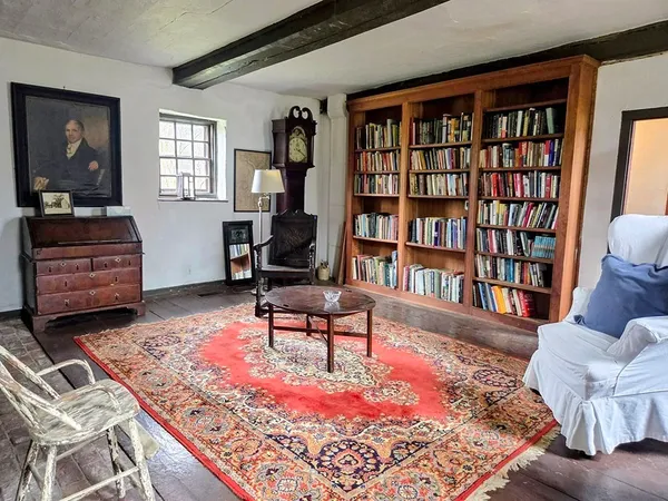 a living room with furniture and a book shelf