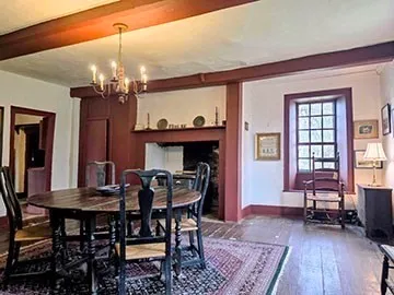 a dining room with furniture a rug and wooden floor