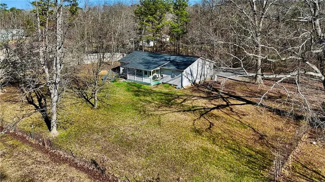 a backyard of a house with table and chairs