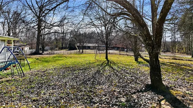 a view of a swimming pool with a yard