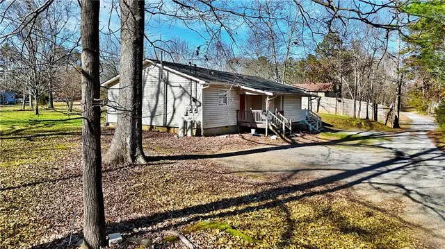 a view of a backyard with wooden fence