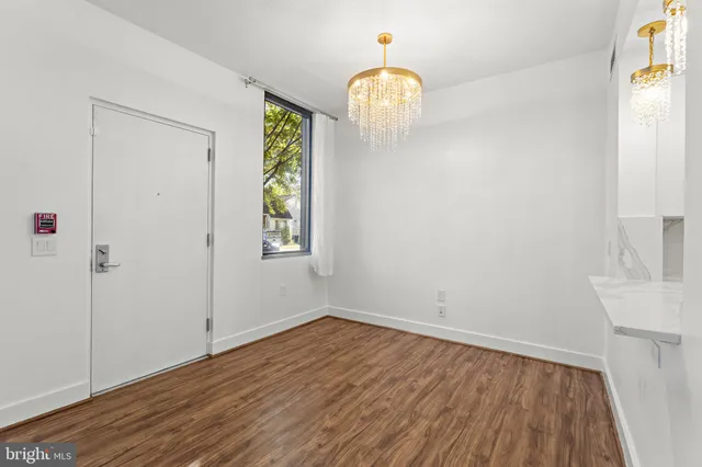 a view of hallway with wooden floor