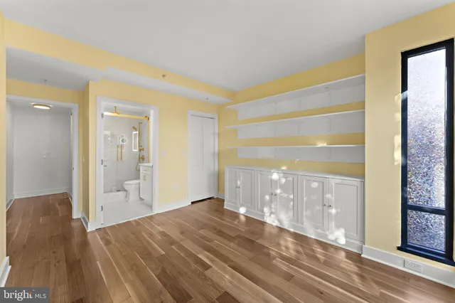 a view of walk in closet with empty racks