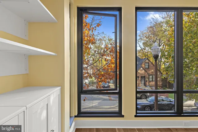 a view of a hallway with wooden floor