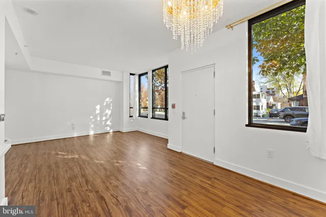 a view of empty room with wooden floor