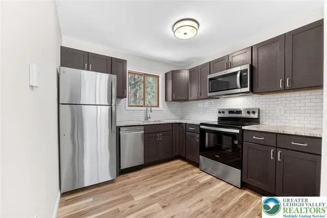 a kitchen with a sink and wooden cabinets