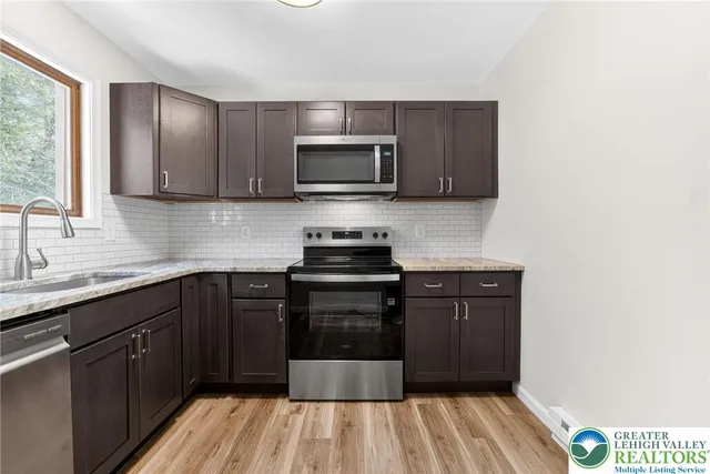 a kitchen with a refrigerator sink and microwave