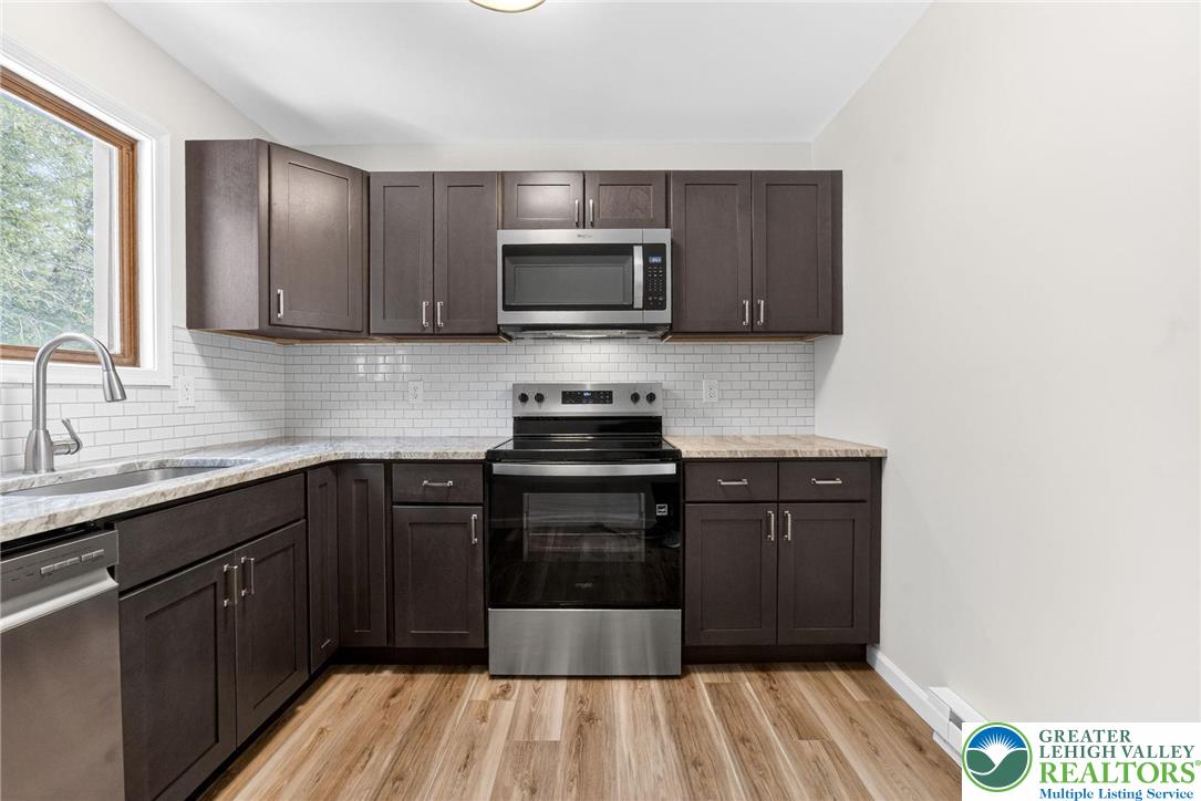 4127 Indian Avenue Pocono Summit, PA 18346 - Photo 12 of 41 a kitchen with a sink and wooden cabinets