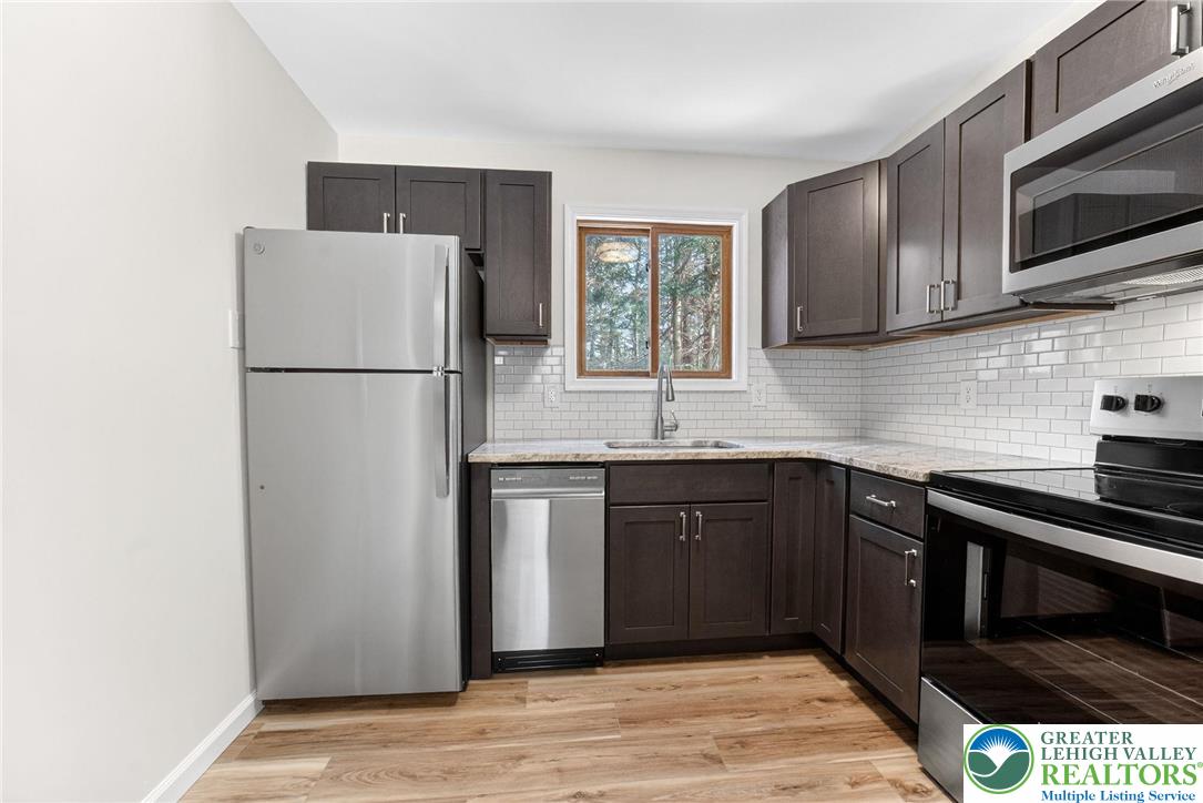4127 Indian Avenue Pocono Summit, PA 18346 - Photo 13 of 41 a kitchen with a refrigerator sink and microwave