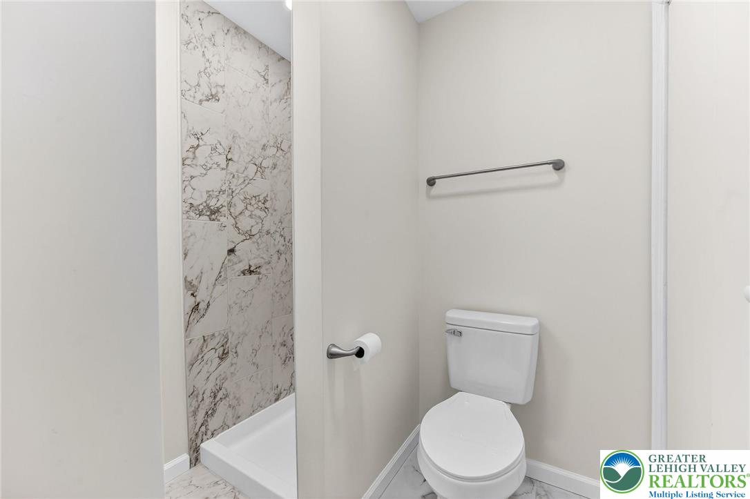 4127 Indian Avenue Pocono Summit, PA 18346 - Photo 16 of 41 a white toilet sitting next to a shower