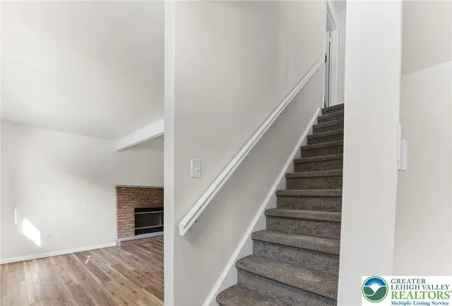 an empty room with windows and ceiling fan