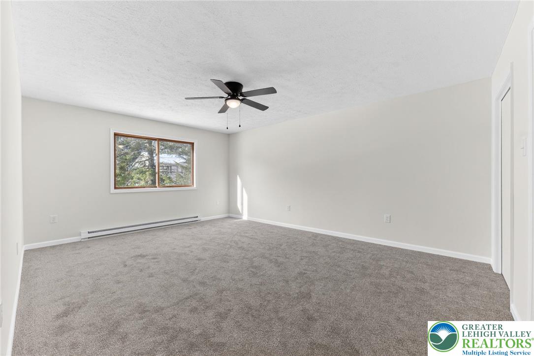 4127 Indian Avenue Pocono Summit, PA 18346 - Photo 19 of 41 an empty room with windows and ceiling fan