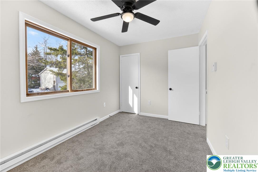 4127 Indian Avenue Pocono Summit, PA 18346 - Photo 24 of 41 a view of an empty room with a window and a ceiling fan