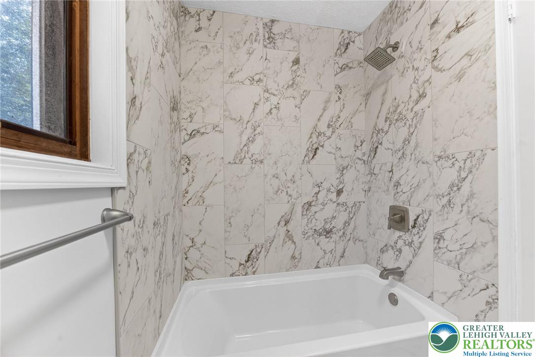 4127 Indian Avenue Pocono Summit, PA 18346 - Photo 30 of 41 a bathroom with a bathtub