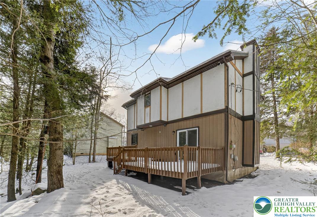 4127 Indian Avenue Pocono Summit, PA 18346 - Photo 31 of 41 a side view of a house with a yard