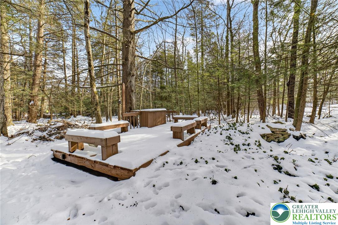 4127 Indian Avenue Pocono Summit, PA 18346 - Photo 32 of 41 a view of a terrace with chairs and a fire pit