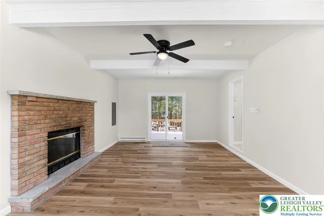 wooden floor in an empty room with a fireplace