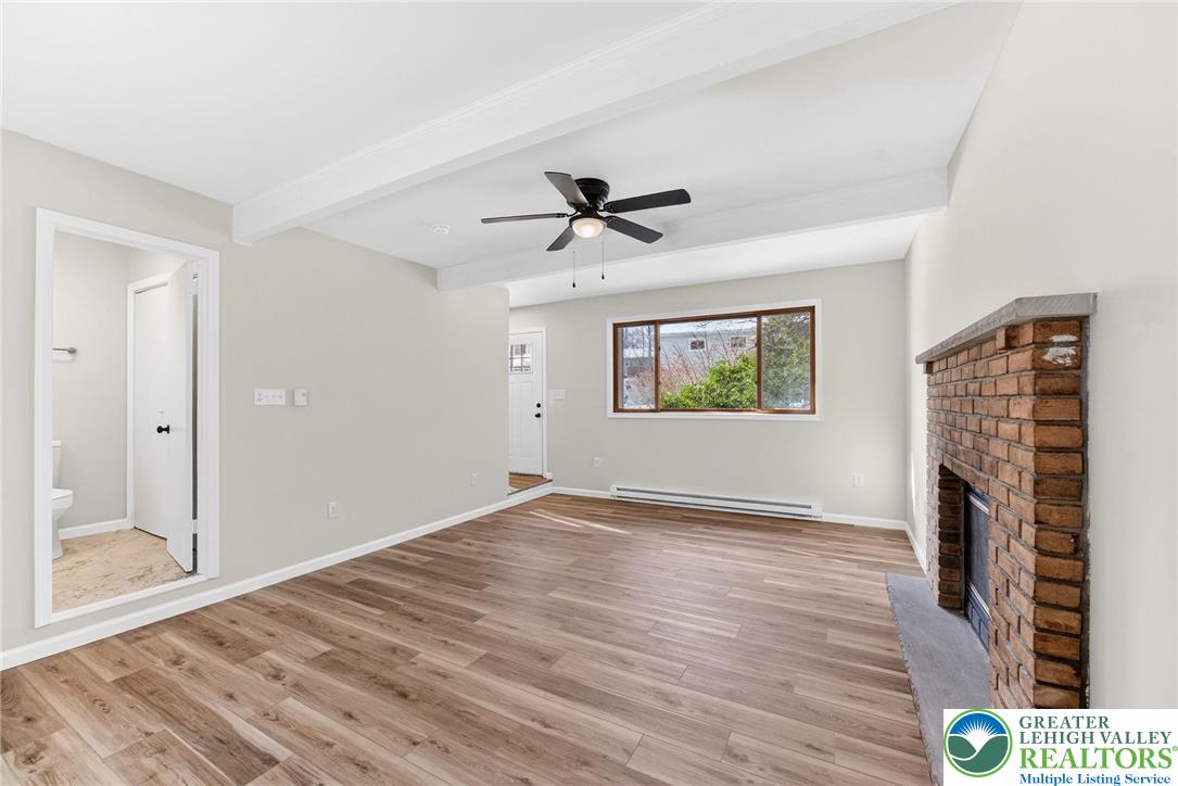4127 Indian Avenue Pocono Summit, PA 18346 - Photo 5 of 41 wooden floor in an empty room with a fireplace