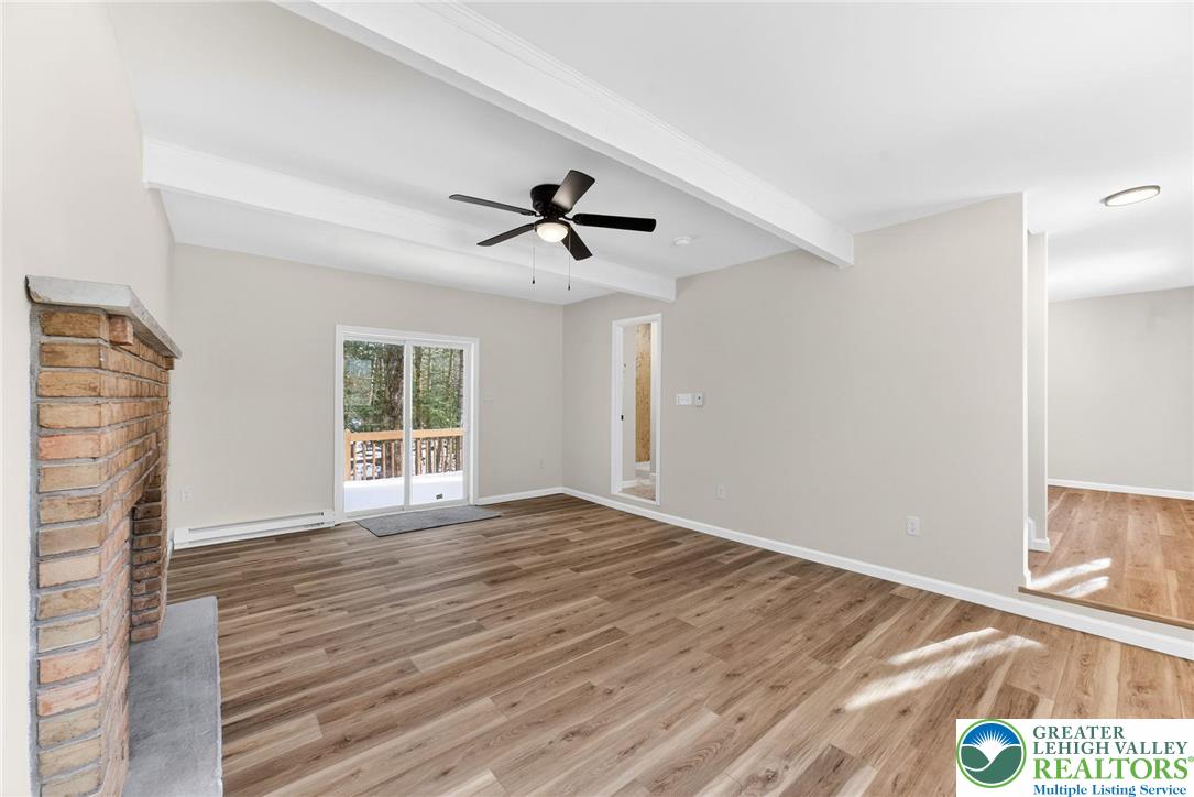 4127 Indian Avenue Pocono Summit, PA 18346 - Photo 7 of 41 a view of an empty room with a window and wooden floor