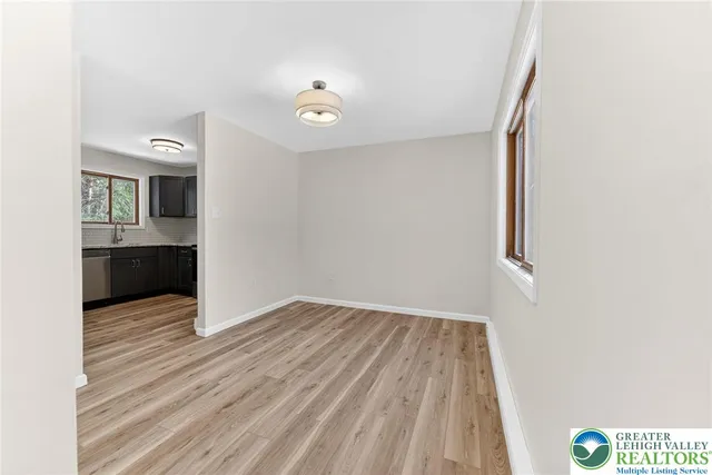 a view of room with window and hardwood floor