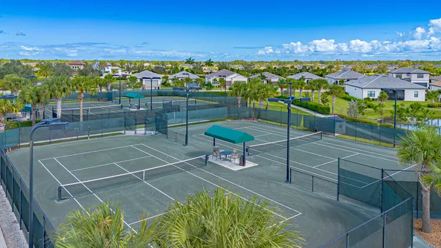 a large kitchen with kitchen island a large counter top and stainless steel appliances