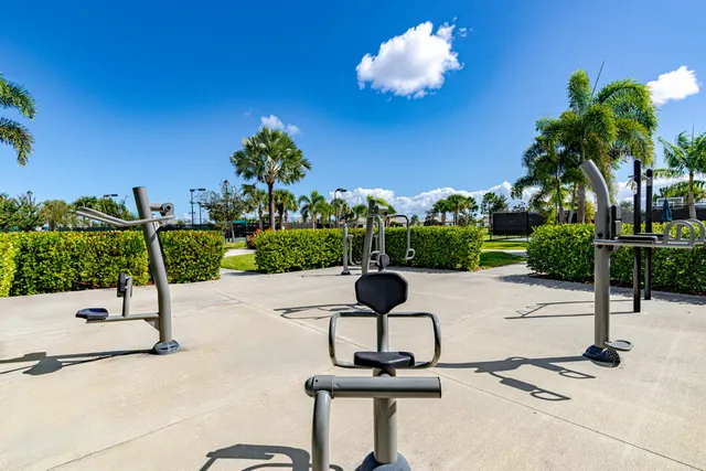 a sign that is sitting in the grass next to a road