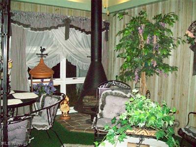2629 Johnnycake Road Mogadore, OH 44260 - Photo 6 of 25 woodburner in right corner of breezeway / sunroom
