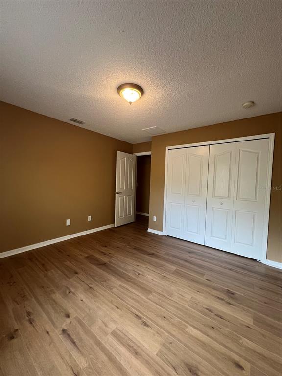 16016 Mulhatton Road Weeki Wachee, FL 34614 - Photo 12 of 14 a view of an empty room with wooden floor