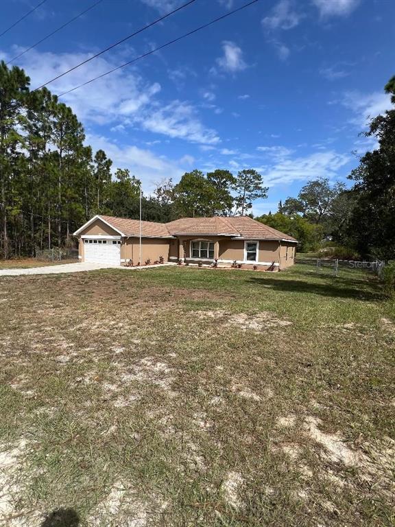 16016 Mulhatton Road Weeki Wachee, FL 34614 - Photo 2 of 14 a view of a lake with a house in the background