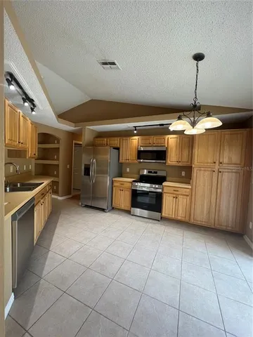 a kitchen with stainless steel appliances granite countertop a sink and cabinets