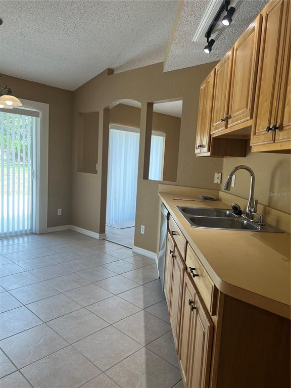 16016 Mulhatton Road Weeki Wachee, FL 34614 - Photo 5 of 14 a kitchen with a sink stove and cabinets