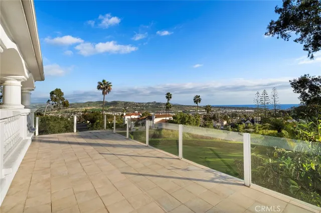 a view of a white house with a swimming pool