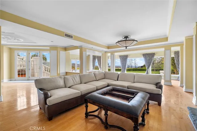 a view of an empty room with window and a kitchen