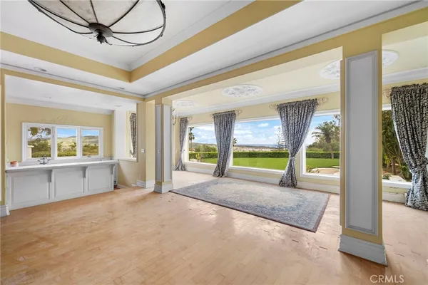 a living room with fireplace furniture and a large window